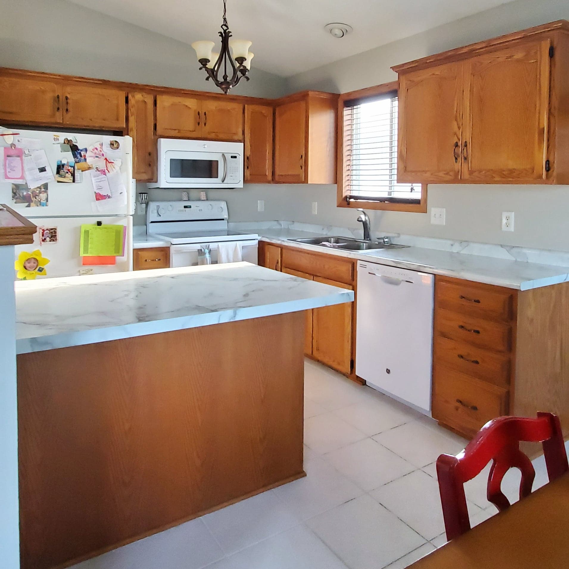 Golden oak kitchen refinished in gray milk paint.